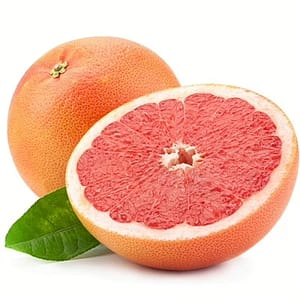 Fresh grapefruit cut in half with bright pink flesh and citrus wedges, highlighting its tangy and refreshing flavor.