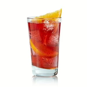 A colorful glass of Hawaiian fruit punch surrounded by slices of pineapple, orange, and tropical fruits, showcasing its sweet tropical flavor.