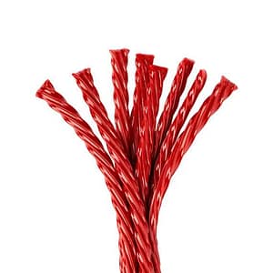 Red licorice candy twists stacked together, highlighting their sweet and fruity candy flavor.